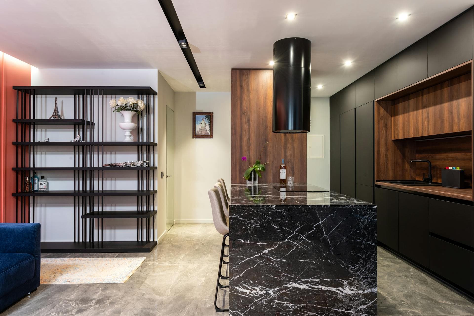 Contemporary kitchen with a dramatic dark veined marble island