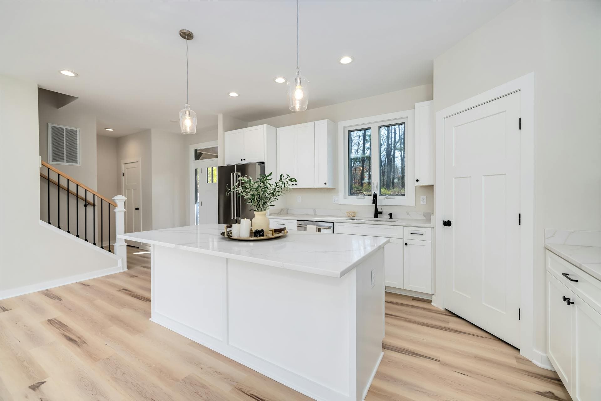 Bright minimalist kitchen with a white waterfall island