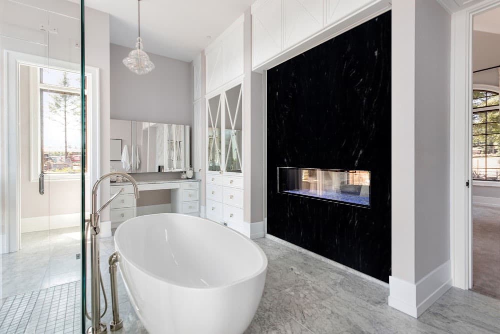 Black granite slab fireplace feature with a linear firebox